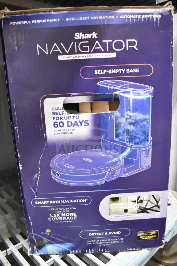 Original box containing a Shark Navigator Robot Vacuum with self-empty base. Features intelligent navigation and self-cleaning brushroll. Box shows minor wear.