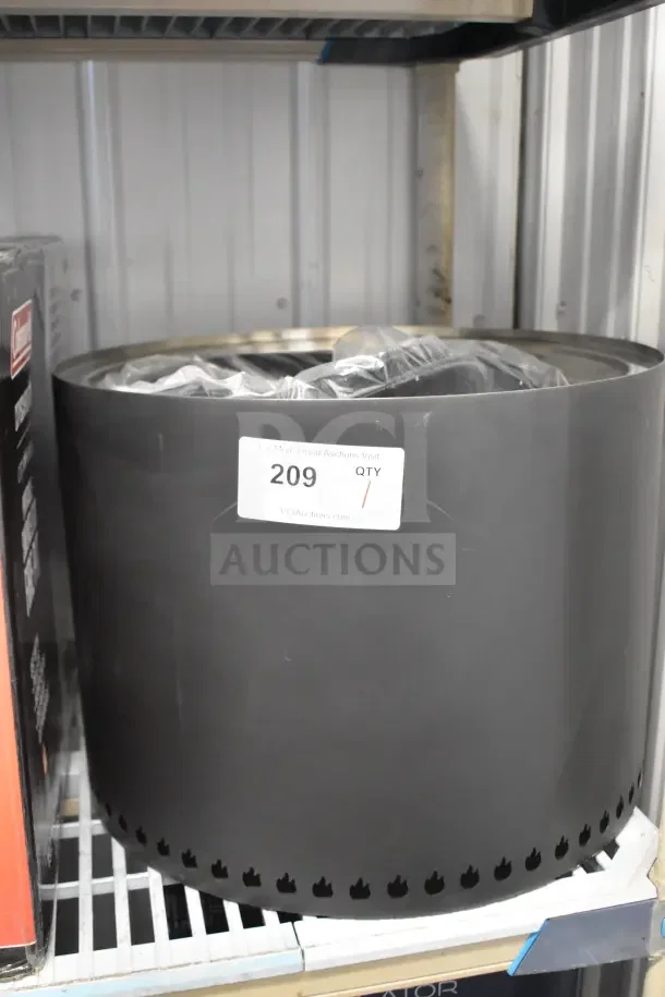 Coleman CCS-200 Portable Smokeless Fire Pit, black, new condition, features ventilation holes for efficient burning. Auction tag visible.