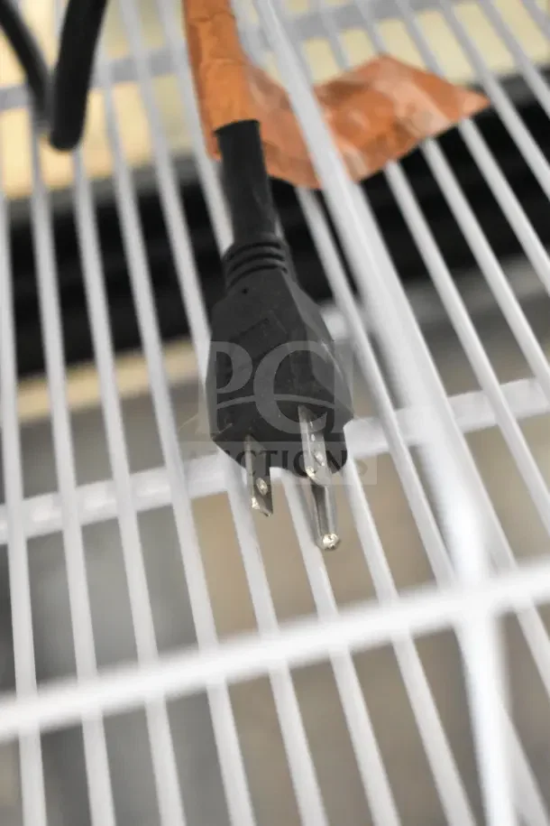 Power cord of IDW GPT33-54FG-N-3-3-N-B-4 cooler on white grid shelf, 115 volts, 1 phase.