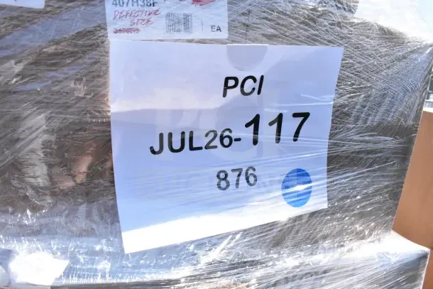 Plastic-wrapped auction lot labeled "PCI JUL26-117." Includes 26 scratch and dent items, such as bar mat, airpot, glasses.