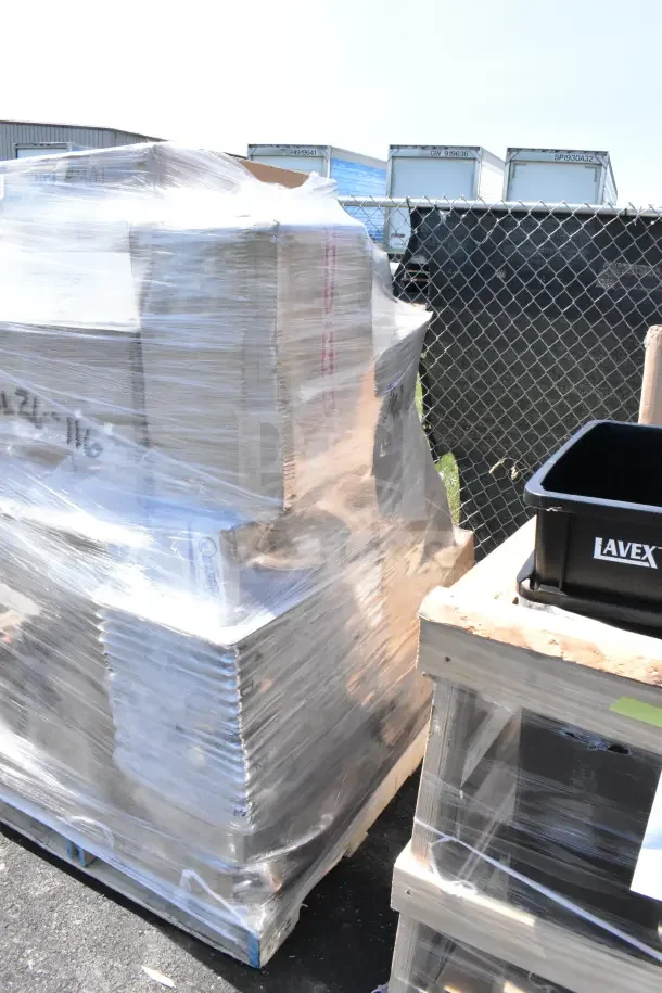 Shrink-wrapped pallet of 28 new scratch and dent items including mat tiles, shelf kit, fan. Visible Lavex container.