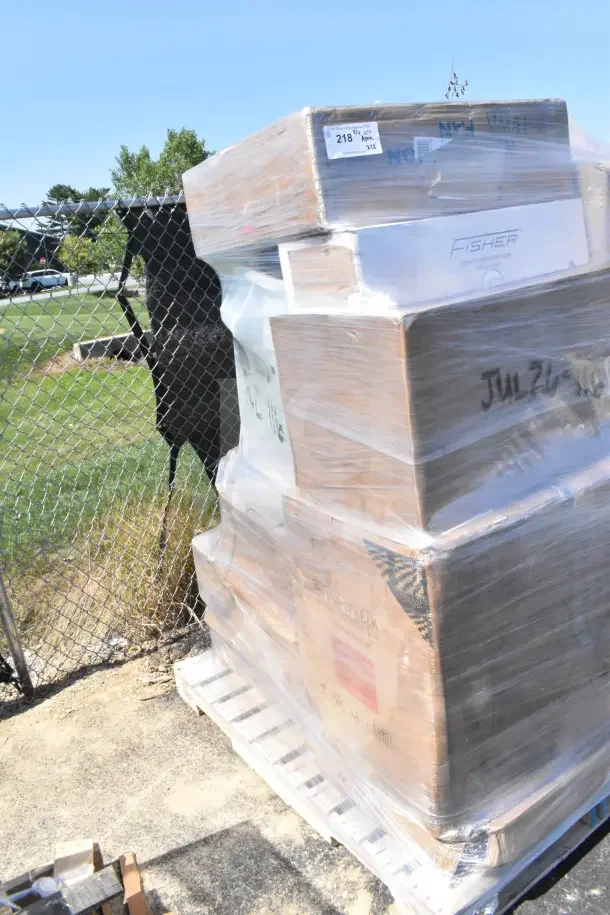 Pallet of 28 brand new scratch and dent items wrapped in plastic, including mat tiles, shelf kit, and fan. Box labels visible.