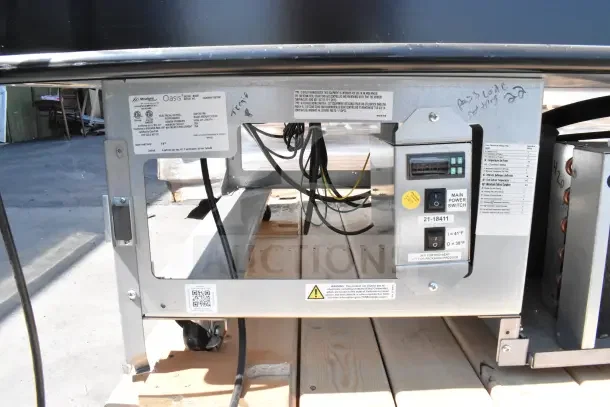 Structural Oasis MI48R commercial open air cooler back view showing control panel, main power switch, and model label.