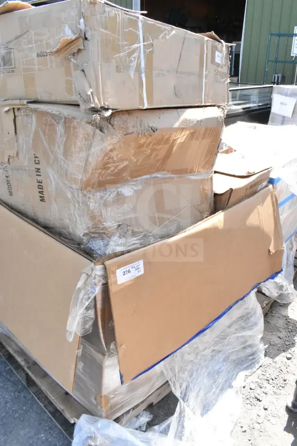 Packed boxes containing 5 brand new items, including Lancaster Table & Seating Black Resin Folding Chair. Visible wear on boxes.