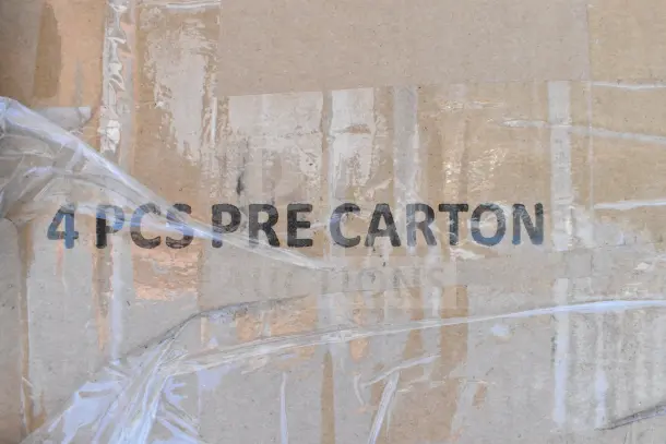 Cardboard box labeled "4 PCS PRE CARTON," packaged in plastic wrap; part of scratch and dent lot with Lancaster folding chair.