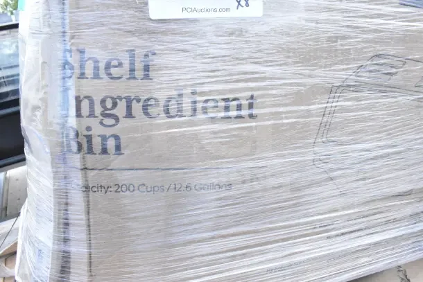 Pallet with new scratch and dent ingredient bin, 200-cup capacity, wrapped in plastic, label indicating 8 items.