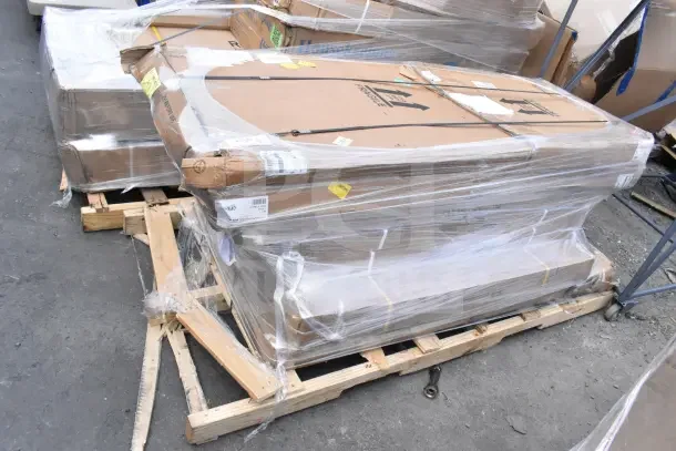 Pallet with six new scratch and dent items, including wire shelves and work table, wrapped in plastic for auction.