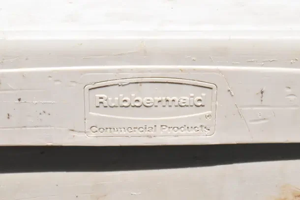 Rubbermaid 2 Tier Cart with visible wear and missing pieces. Rubbermaid Commercial Products logo imprinted.