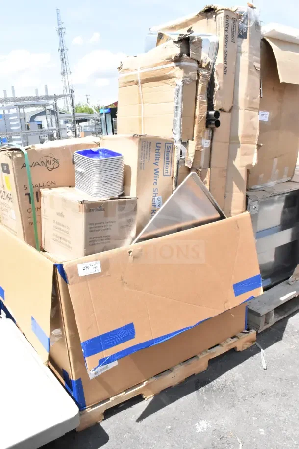 Box of 12 new scratch and dent items on a pallet, including AvaMix Tilting Blender. Visible packaging damage.