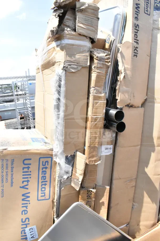 Twelve new scratch and dent items, including an AvaMix tilting blender. Damaged boxes visible with Steelton wire shelf kits.