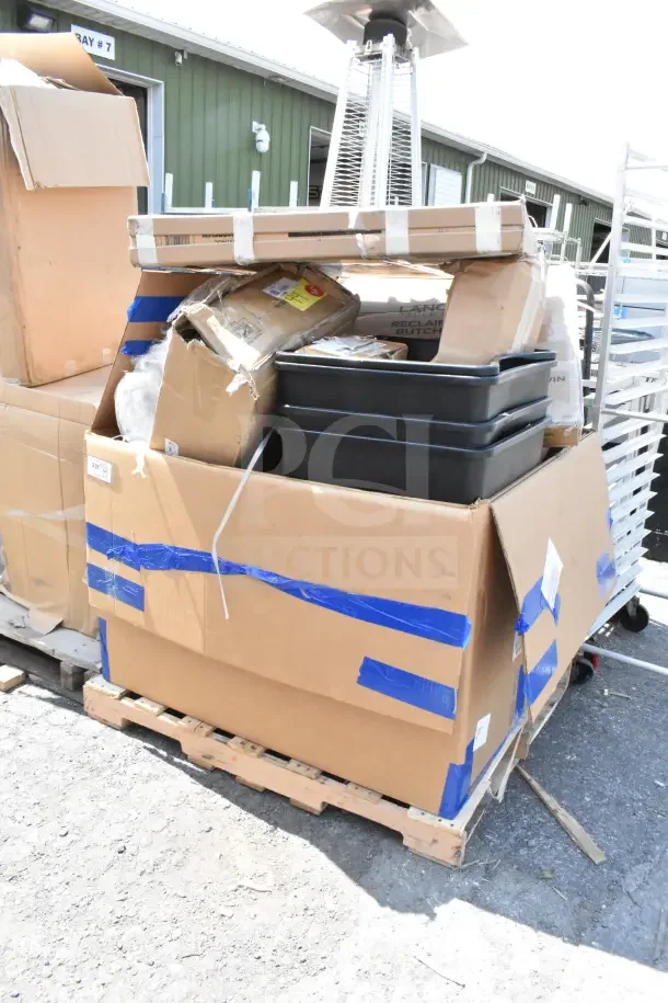 Large cardboard box containing 15 scratch and dent items like tabletops and trash cans; new condition, on a pallet.