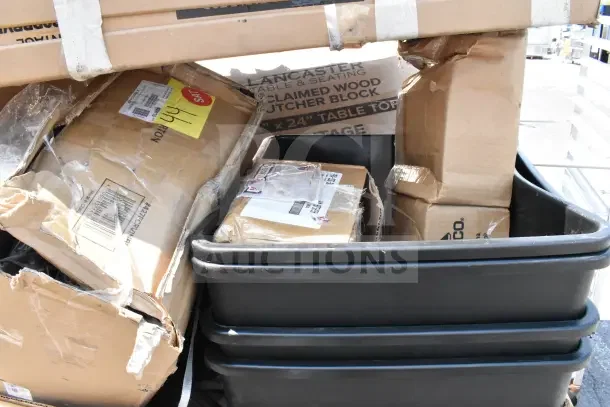 15 brand new scratch and dent items including tabletops and trash cans in boxes. Labels show discounts and shipping info.