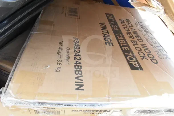 Cardboard box of Lancaster reclaimed wood butcher block tabletop, 24x24 inches, new condition, minor dents visible.