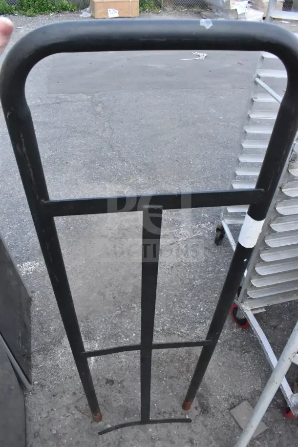 Black metal handles for furniture dolly in used condition, showing minor wear.