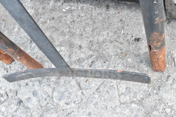 Three metal handles for furniture dolly, slightly rusted, placed on concrete ground. Auction offers three times your bid.