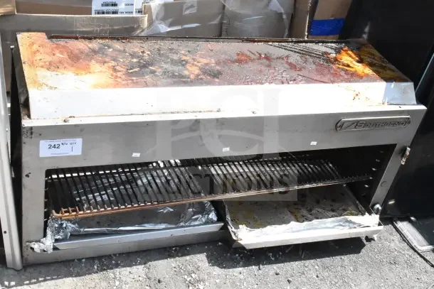 Southbend commercial gas-powered cheese melter with visible rust and wear, open front design, and metal racks.