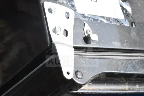 Mini cooler corner close-up with metal brackets and fasteners. Black exterior, indicating 115 volts, 1 phase.