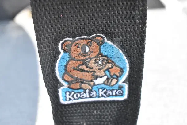 Koala Kare logo on a black fabric, representing the brand associated with the high chair set.