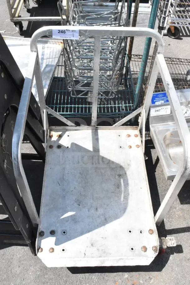 Commercial cart on casters, metal frame, rectangular platform, worn condition with visible bolts and rust marks, auction tag "246".