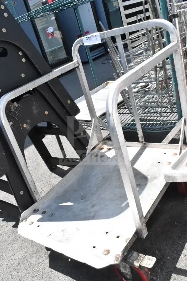 Commercial cart on casters with metal frame, sturdy construction. Visible wear, ideal for heavy-duty transport tasks.