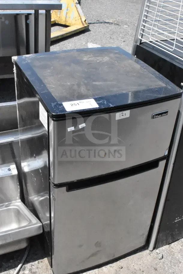 Magic Chef HMDR310SE Mini Cooler with Freezer, stainless steel finish, visible scratches, 120V, 1 Phase, model label intact.