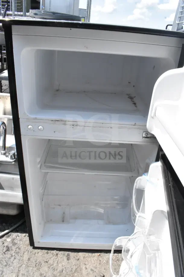 Magic Chef HMDR310SE Mini Cooler with freezer, 120 volts, 1 phase. Visible interior wear. Model details not shown.