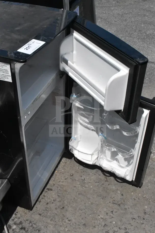 Magic Chef HMDR310SE Mini Cooler with freezer, black, open door, clean interior, visible door shelves, 120 volts, 1 Phase.
