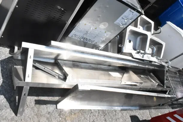 5 various wall mount shelves in metal, used condition, stacked for auction. Includes brackets, some wear visible.