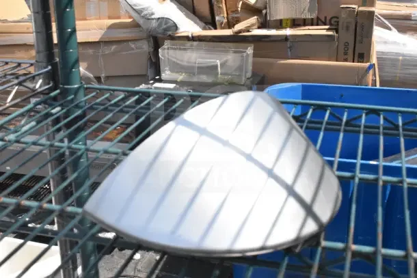 Green 4-tier wire shelving unit, used, holds baking pans and a dunnage rack. Buyer disassembly required. Consider freight.