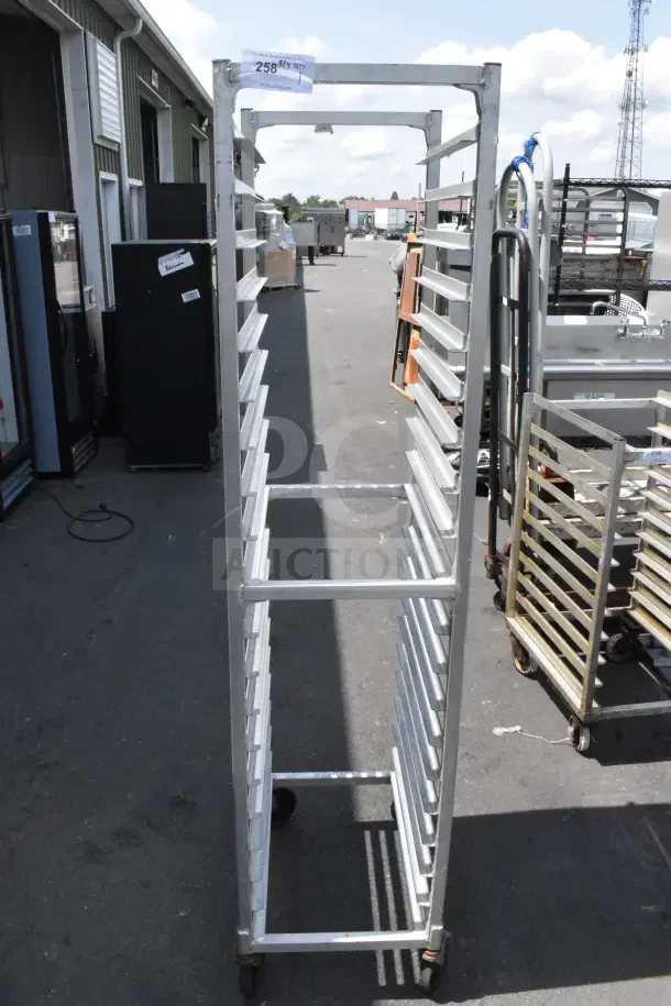 Newage Commercial Pan Transport Rack on casters, metal construction, multiple shelves, good condition, auction tag visible.