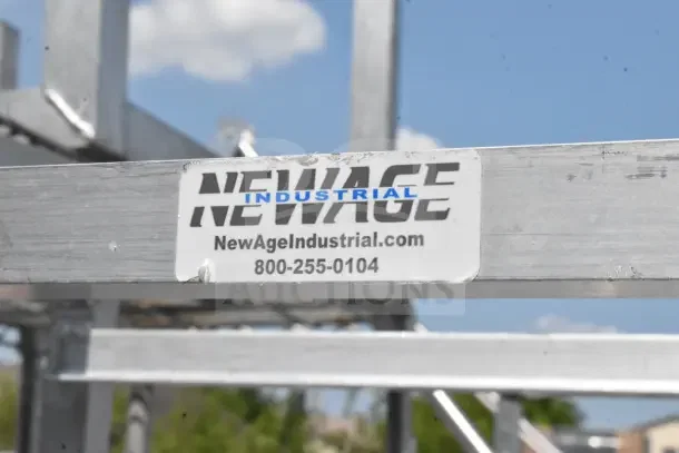 Newage Commercial Pan Transport Rack with label showing brand and website. Features durable metal frame and commercial casters.