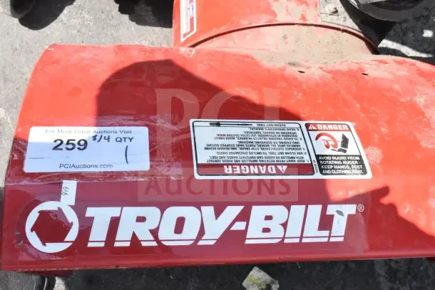 Troy Bilt Storm 2620 Snow Blower, red finish, visible warning labels, auction tag reads "259" and "8/4 QTY 1."