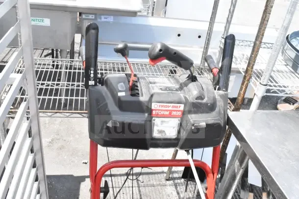 Troy Bilt Storm 2620 Snow Blower, red and black, visible controls and brand label. Appears in good condition.