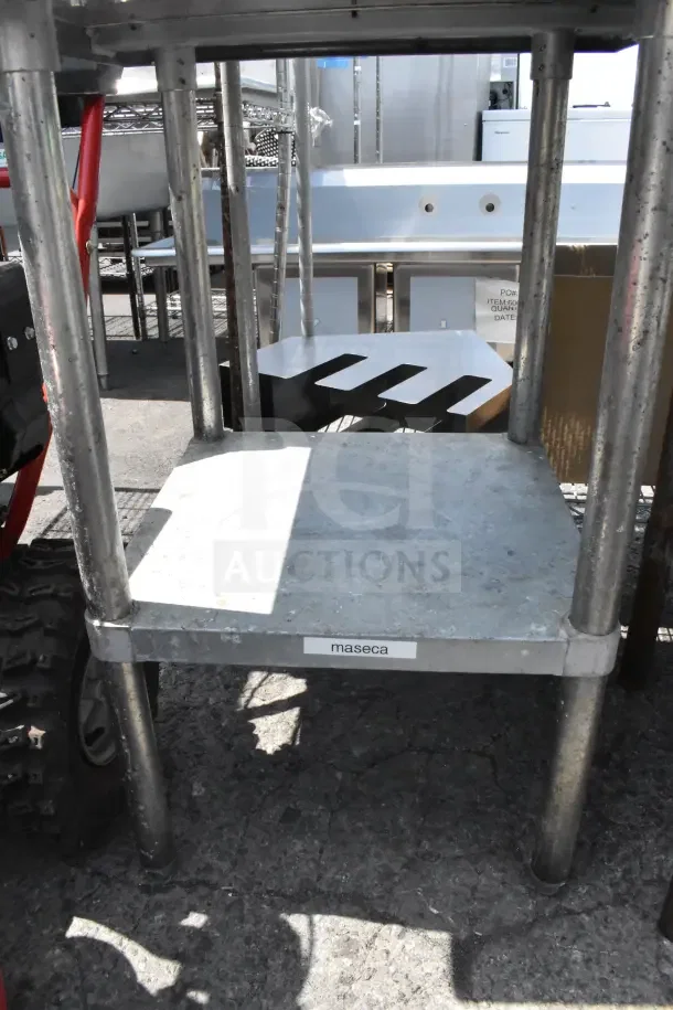 Commercial stainless steel table with under shelf, sturdy construction, visible "maseca" label, suitable for kitchen use.