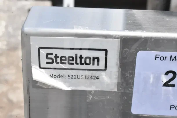 Steelton 522US12424 utility sink tag, indicating model number. Stainless steel material with precise dimensions for faucet.