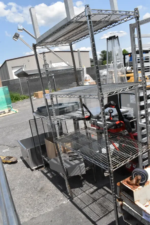 Chrome finish 4-tier wire shelving unit with contents, including a dunnage rack. Buyer must dismantle. Consider freight charges.