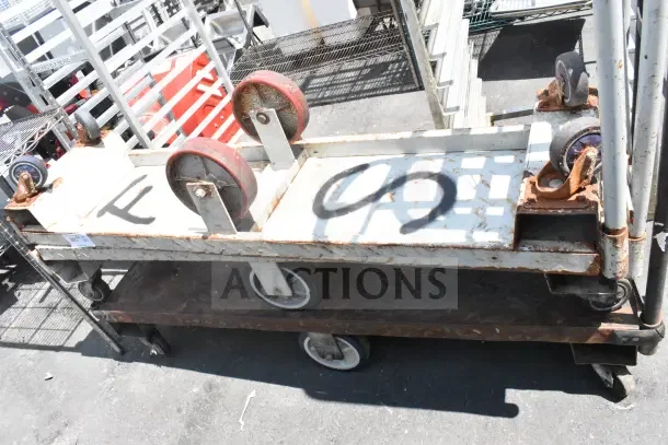 Three U Boat carts with commercial casters, worn condition. Metal framework visible with some rust. Various spray-painted markings.