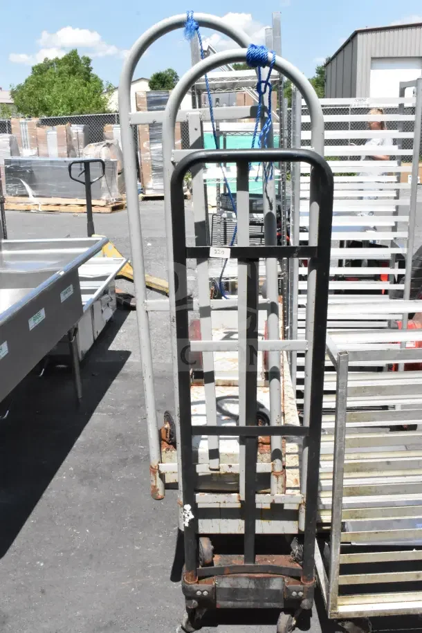 Three U-Boat carts on commercial casters, metal frames, moderate wear, outdoor setting. Includes visible tags and markings.