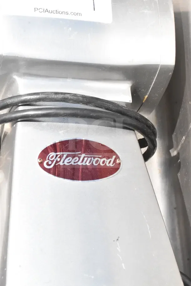 Fleetwood countertop cheese grater, 115 volts, 1 phase, features a sleek metallic finish with a visible brand label.
