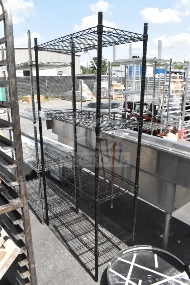 Black 4-tier wire shelving unit, industrial style. Buyer must dismantle for transport. Consider freight charges.