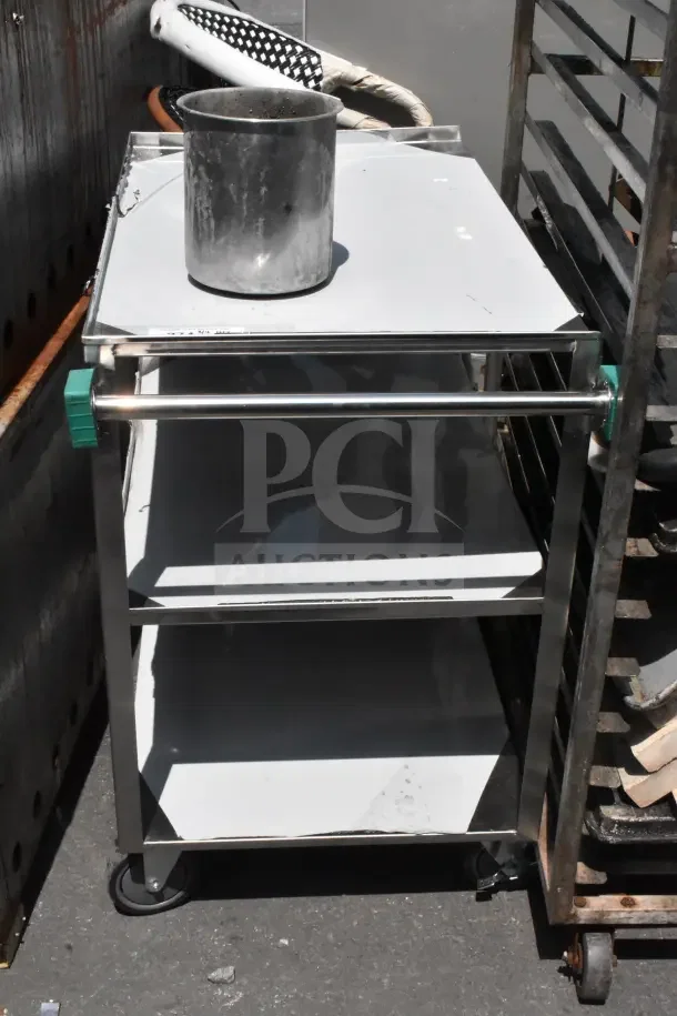 Commercial 3 tier cart with sturdy commercial casters, showing signs of use. Ideal for heavy-duty applications.