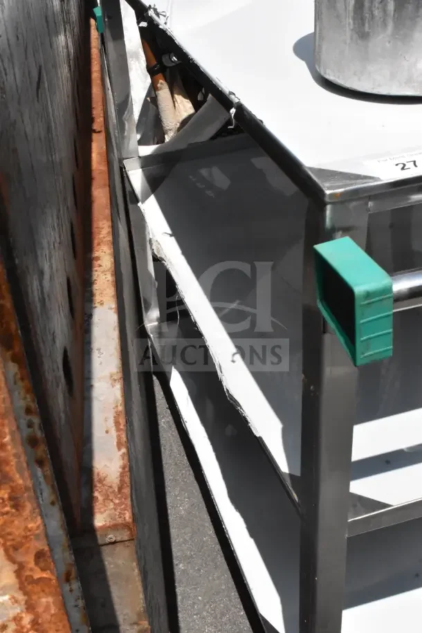 Commercial 3-tier cart with metal frame, featuring green handles and commercial casters. Some wear visible on sides.