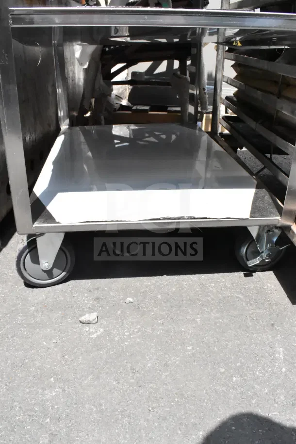 Commercial 3-tier stainless steel cart with sturdy shelves on heavy-duty casters, ideal for restaurant use.