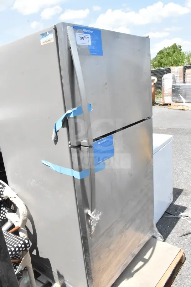 Stainless steel reach-in cooler with freezer, 115 volts, 1 phase. Minor scuffs, visible blue tape and sticker on door.