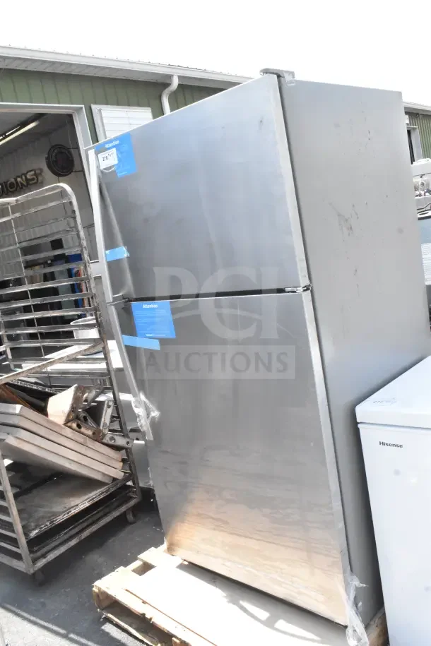 Reach In Cooler with Freezer, stainless steel, 115 volts, 1 phase, visible labels, used condition, on wooden pallet.