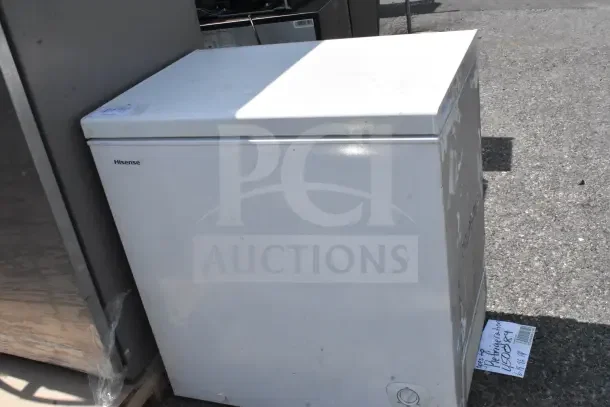 Hisense chest freezer, 115 volts, 1 phase, white exterior, visible wear, model tag attached, suitable for extra storage.