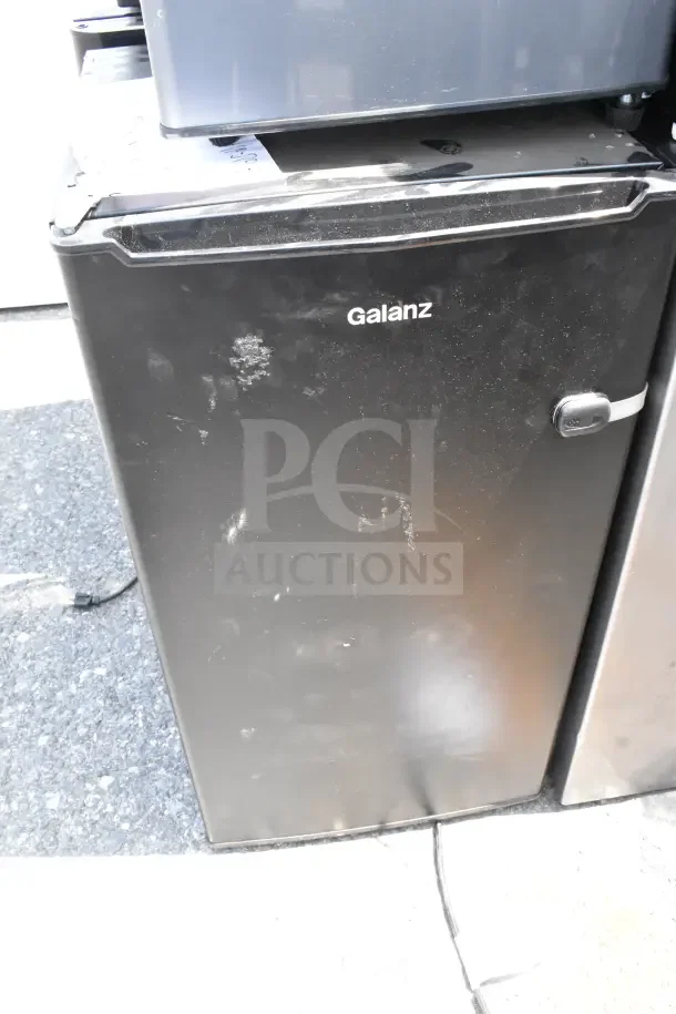 Four mini coolers, including Galanz and Haier, in varying used conditions, 120V, 1 phase. Minimal surface marks visible.