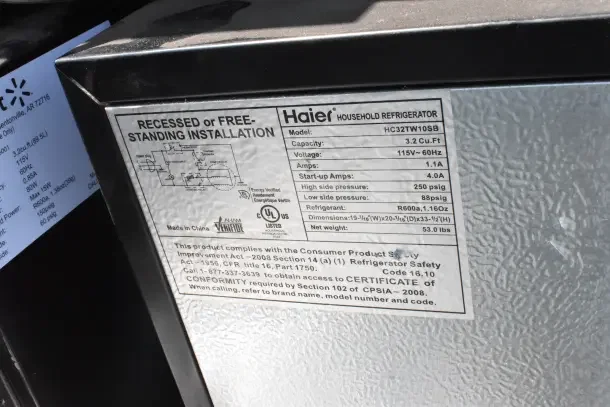 Four mini coolers including Galanz and Haier models. Haier model HC32TW10SB label shows 3.2 cu. ft. capacity, 120 volts, 1 phase.