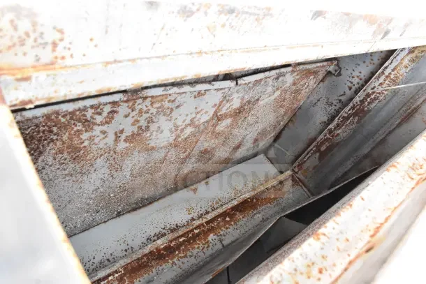 Two Bakers Pride commercial gas pizza ovens with visible rust on metal surface, indicating wear.