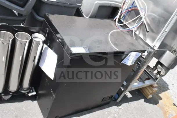Frigidaire Gallery chest freezer, black, 115 volts, 1 phase, minor surface wear visible, suitable for large storage needs.
